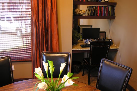 Springridge Apartments office/conference room inside clubhouse with desk area and computer, table and chairs